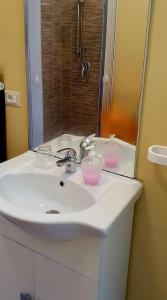 a bathroom sink with two glasses on top of it at Agape casa vacanze in Giardini Naxos