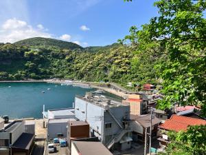 a view of a town with a body of water at Stay Do in Oshima