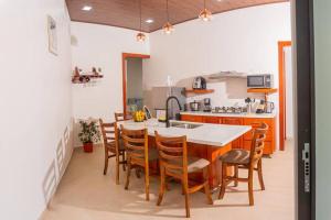 a kitchen with a table and chairs in a kitchen at Villa Aurora with Jacuzzi in La Fortuna in Fortuna