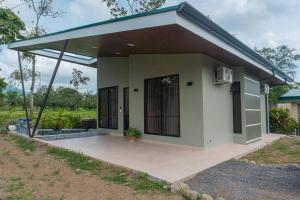 a small house with a porch at Villa Aurora with Jacuzzi in La Fortuna in Fortuna