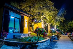 a house with a garden in front of it at night at Catba Papillon Garden Bungalows & Resort in Cat Ba