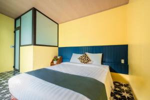 a bedroom with two beds and a window at Catba Papillon Garden Bungalows & Resort in Cat Ba