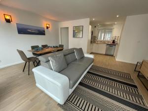 a living room with a couch and a table at Appartement Central, Tout Équipé et Confortable pour 4 Personnes à Arcachon - FR-1-474-244 in Arcachon