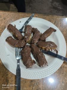a plate of food with chocolate on a table at Gold star guest house and cafe in Tosh