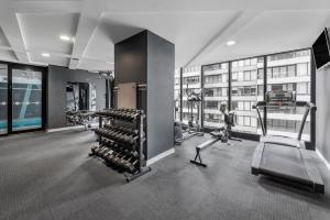 a gym with treadmills and exercise equipment in a building at Imagine Southbank in Melbourne