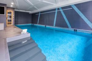 a swimming pool with blue water in a room at Imagine Southbank in Melbourne