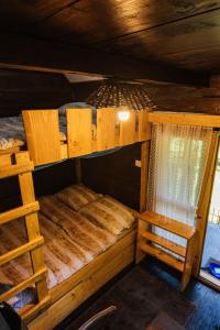 a bedroom with two bunk beds in a cabin at Treehouse KUPARI Nacionalni park Risnjak in Čabar