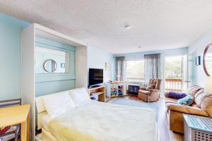 a bedroom with a bed and a living room at Proposal Rock Charmer in Neskowin