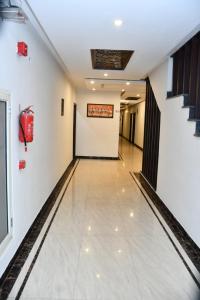 an empty corridor in a building with a bowling alley at Hotel Royal Comfort Inn in Pinjaur
