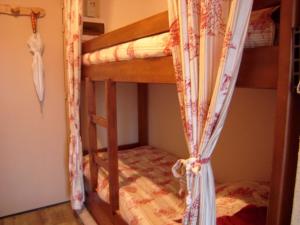 a bedroom with two bunk beds with curtains at Appartement Crest-Voland, 1 pièce, 4 personnes - FR-1-733-115 in Crest-Voland