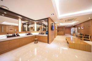 a large bathroom with two sinks and two mirrors at Benikea Hotel Bizinn in Wonju