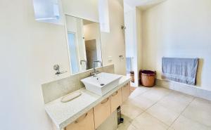 a bathroom with a sink and a mirror at Shore Bird On Moreton in Tangalooma +19 photos