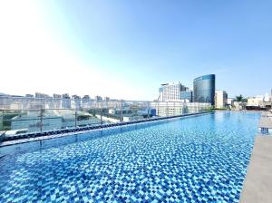 a large swimming pool with a city skyline in the background at Somerset Central Bundang in Seongnam