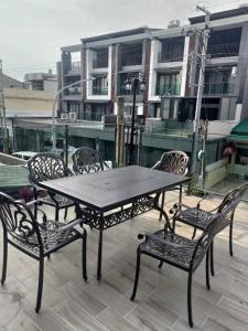 una mesa negra y sillas en un patio en 春雨漫居 Spring Rain Hostel, en Meishan