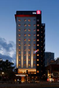 a tall building with lights on the side of it at the b asakusa in Tokyo