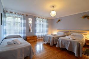 a room with two beds with white sheets on them at Bed & Breakfast Ai Fontana in Villar Pellice