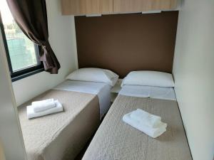 A bed or beds in a room at Garda Di Vino Agricamping & Wine Shop Lazise