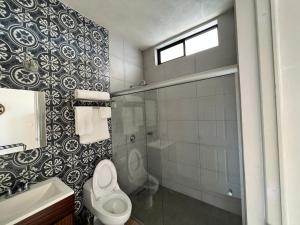 a bathroom with a toilet and a shower and a sink at Hotel Reforma in Tuxpan +17 photos