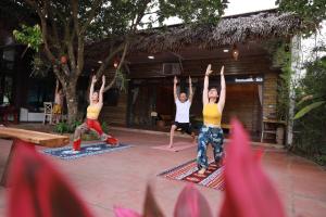 a group of people doing a yoga pose at 6Senses Garden Homestay in Hòa Bình