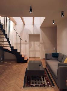 a living room with a couch and a table at Buda-city house in Trnávka