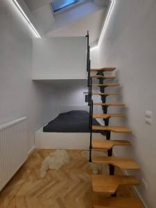 a room with a staircase leading to a bedroom at Buda-city house in Trnávka