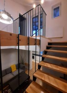 a staircase in a room with a couch and a stair case at Buda-city house in Trnávka