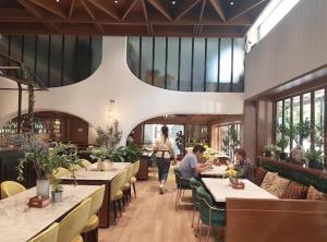a restaurant with tables and people sitting at tables at The 3sis Hotel in Chiang Mai