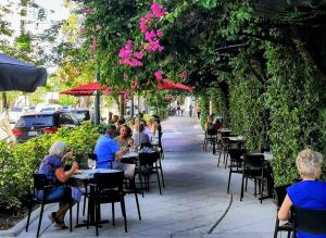 a group of people sitting at tables at a restaurant at Luxury 3BD house, Siesta Key Beach in Sarasota