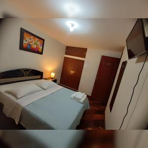 a small bedroom with a bed in a room at Hotel la encantada in Cajamarca