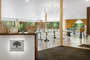 a restaurant with tables and chairs in a room at Cedar Creek Lodges in Mount Tamborine