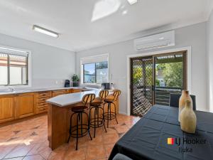 a kitchen with a table and chairs in a room at Bonnie Doon in Iluka
