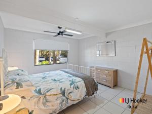 a bedroom with a bed and a ceiling fan at Bonnie Doon in Iluka