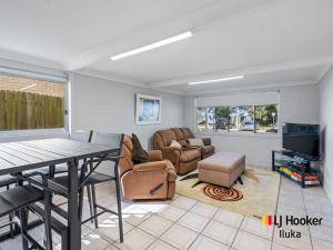 a living room with a table and a couch at Bonnie Doon in Iluka