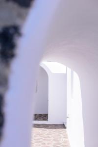 a hallway with white walls and an open door at CASA ARISTA in Fira