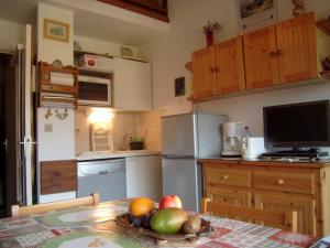a kitchen with a table with a bowl of fruit on it at Appartement Crest-Voland, 1 pièce, 4 personnes - FR-1-733-113 in Crest-Voland
