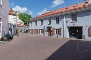 a cobblestone street in a town with white buildings at Luxury apartment in Pilies street in Vilnius