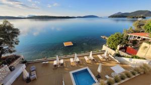 a view of a lake with chairs and a swimming pool at TRL Lefkada in Nydri