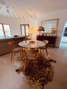a living room with a table and chairs and a couch at Casa Maya in Benissa