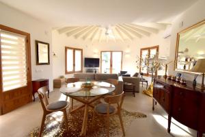 a living room with a table and a couch at Casa Maya in Benissa