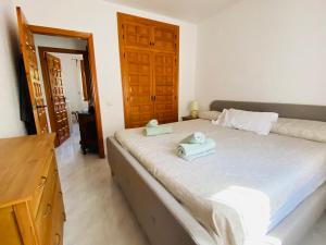 a bedroom with a bed with two towels on it at Casa Maya in Benissa +20 photos