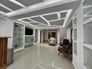a living room with a coffered ceiling and a television at Hotel Reforma in Tuxpan