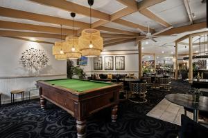 a pool table in a room with a bar at Cedar Creek Lodges in Mount Tamborine