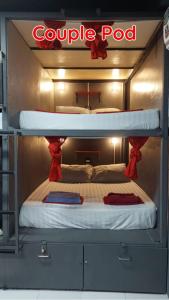 a bunk bed in a room with a double bed at Dormsin Social in Phi Phi Don