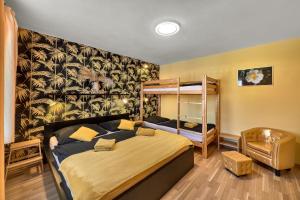 a bedroom with a bed and a bunk bed at Penzion V Roklich & Apartments V Roklich in Ricany +82 photos