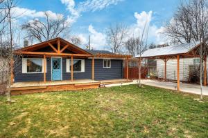 a blue house with a porch and a gazebo at Little Blue Bungalow on Boise's Bench, Pet Friendly, Fully Fenced yard with doggie door! 2 miles from BSU, 5 minutes from Downtown Boise, Desk and workstation for remote workers, 2 TV's large walk-in closet, Good for mid-term stays in Boise