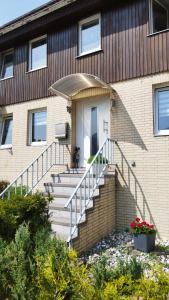 a house with a staircase leading to the front door at Ferienwohnung Beckmann in Bad Lauterberg