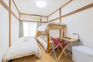 a bedroom with a bunk bed and a desk at Wabi Sabi Hostel in Tokyo
