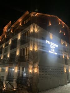 a building with a sign on the side of it at night at VortexLux in Kopaonik