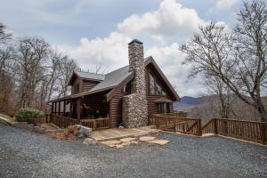 une cabane en rondins avec une véranda et une terrasse dans l'établissement Sugar Bear, à Sugar Mountain