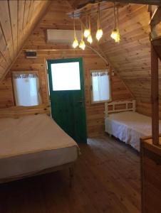 a bedroom with two beds in a wooden cabin at Pera Garden Airport Hotel in Arnavutköy